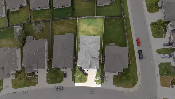 an aerial view of a house with outdoor space swimming pool