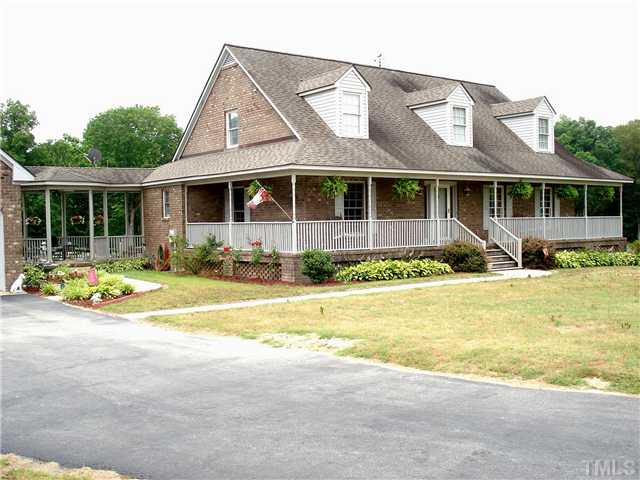 Brick home w/ wrap around porch,new roof, breezeway to garage and pool area in back.