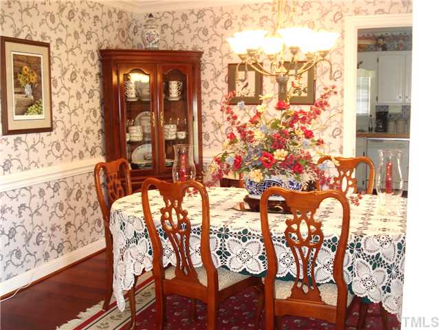 4083 Massengale Road Whitakers, NC 27891 - Photo 11 of 17 Formal dining room features hardwood floor and chair rail.