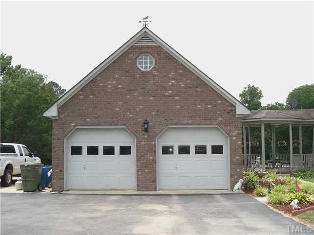 Two car garage with bonus room up is attached to home by a breezeway that also leads to pool area.