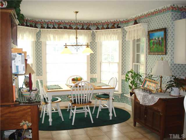 4083 Massengale Road Whitakers, NC 27891 - Photo 10 of 17 Cozy breakfast area in kitchen has a bay window with view of the pastures bordering the creek.