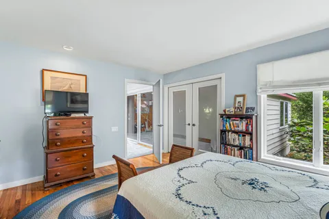 a living room with furniture and a book shelf