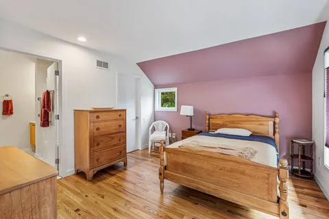 a bedroom with a bed and a dresser