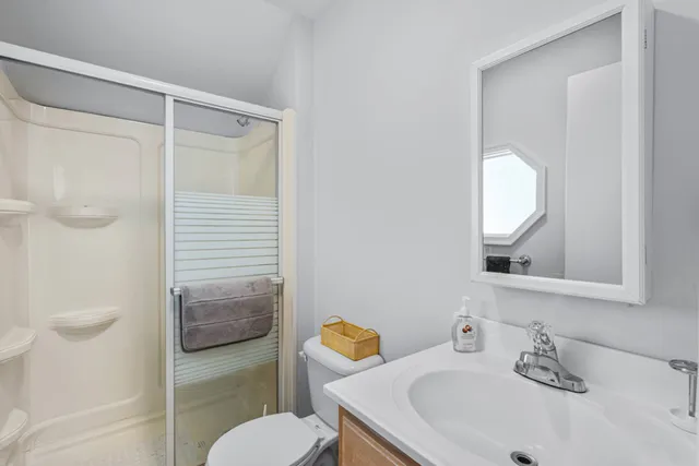 a bathroom with a sink toilet and shower