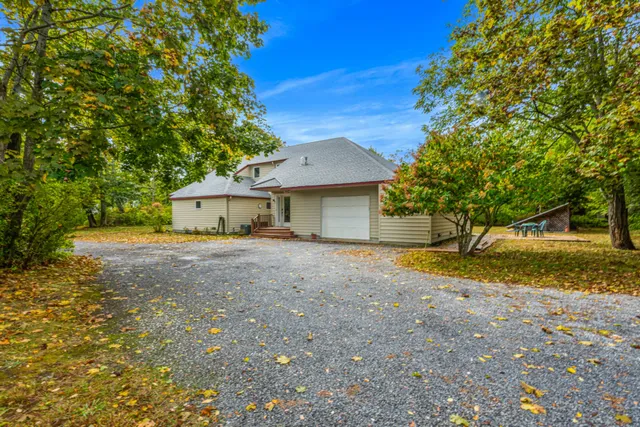 a front view of a house with a yard and a garage