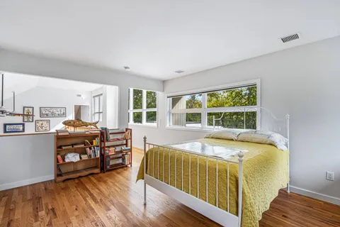 a bedroom with furniture and a large window