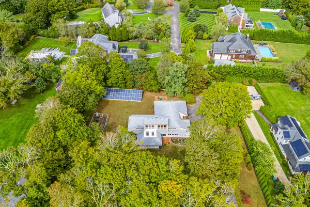 an aerial view of a house with a yard swimming pool outdoor seating and yard