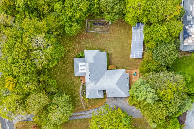 an aerial view of a house with a yard and garden