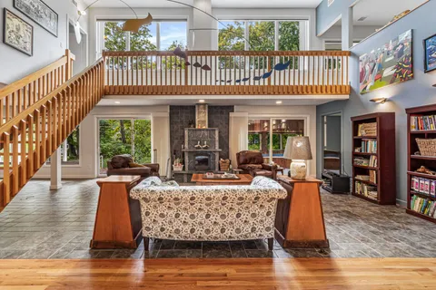 a dining room with furniture window and wooden floor