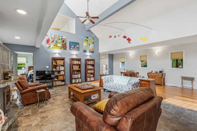 a living room with furniture and a ceiling fan