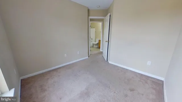 a view of an empty room and closet area