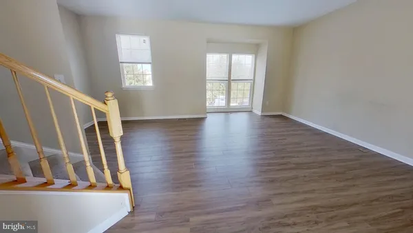 a view of an entryway with wooden floor and windows