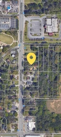 a view of a fire pit with large trees