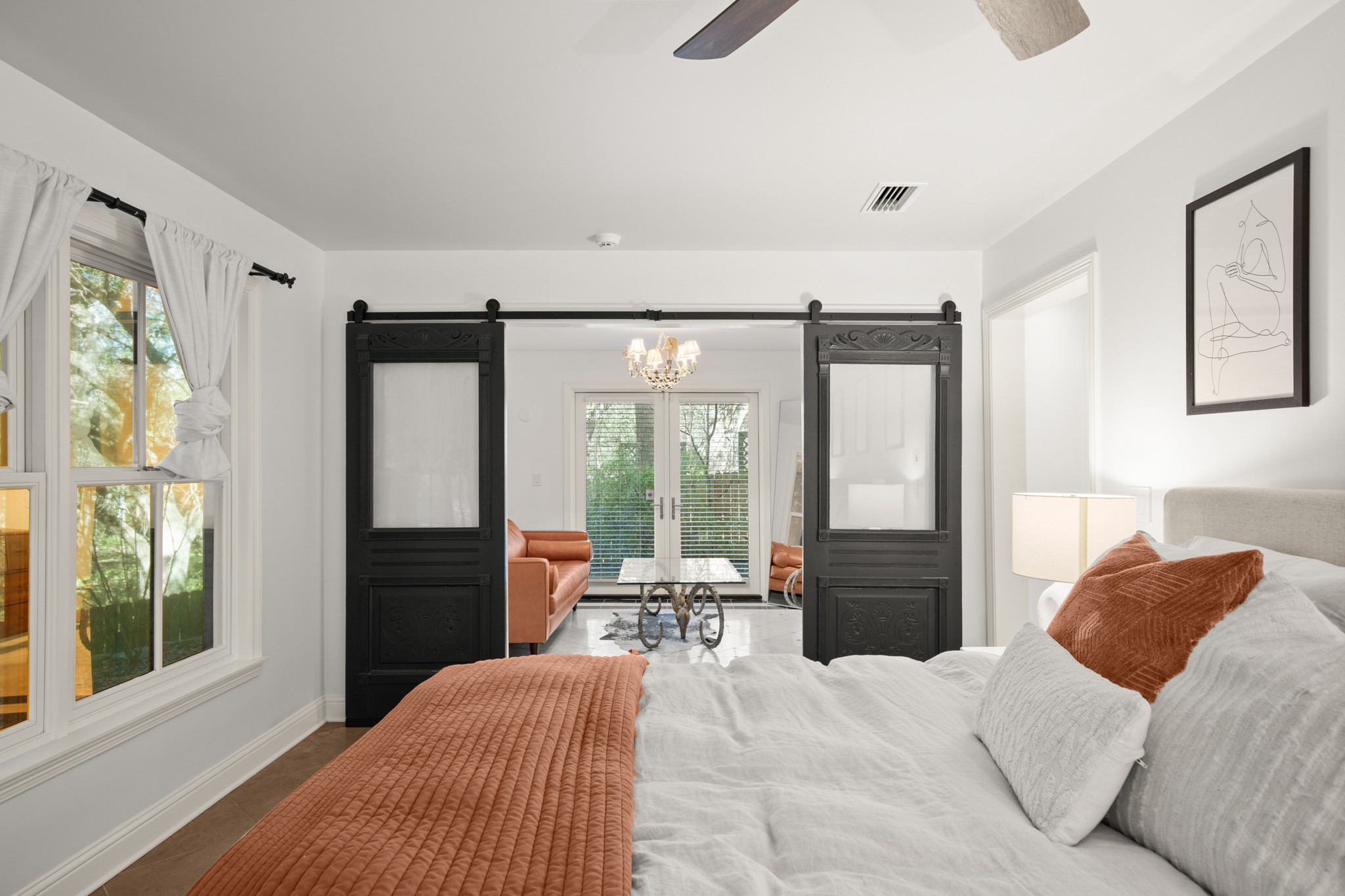 1601 Whitney Way Austin, TX 78741 - Photo 23 of 30 Sliding barn doors reveal an adjacent living space, perfect for relaxing.