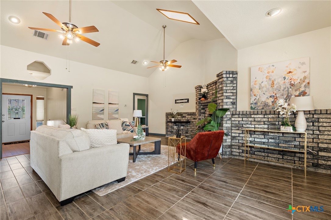 711 Mueller Street Copperas Cove, TX 76522 - Photo 14 of 48 a living room with furniture a chandelier and a rug
