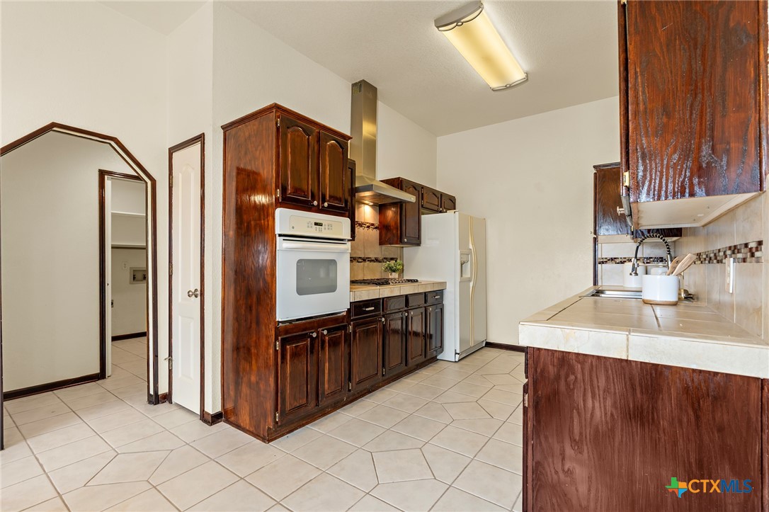 711 Mueller Street Copperas Cove, TX 76522 - Photo 16 of 48 a kitchen with stainless steel appliances granite countertop a refrigerator and a sink