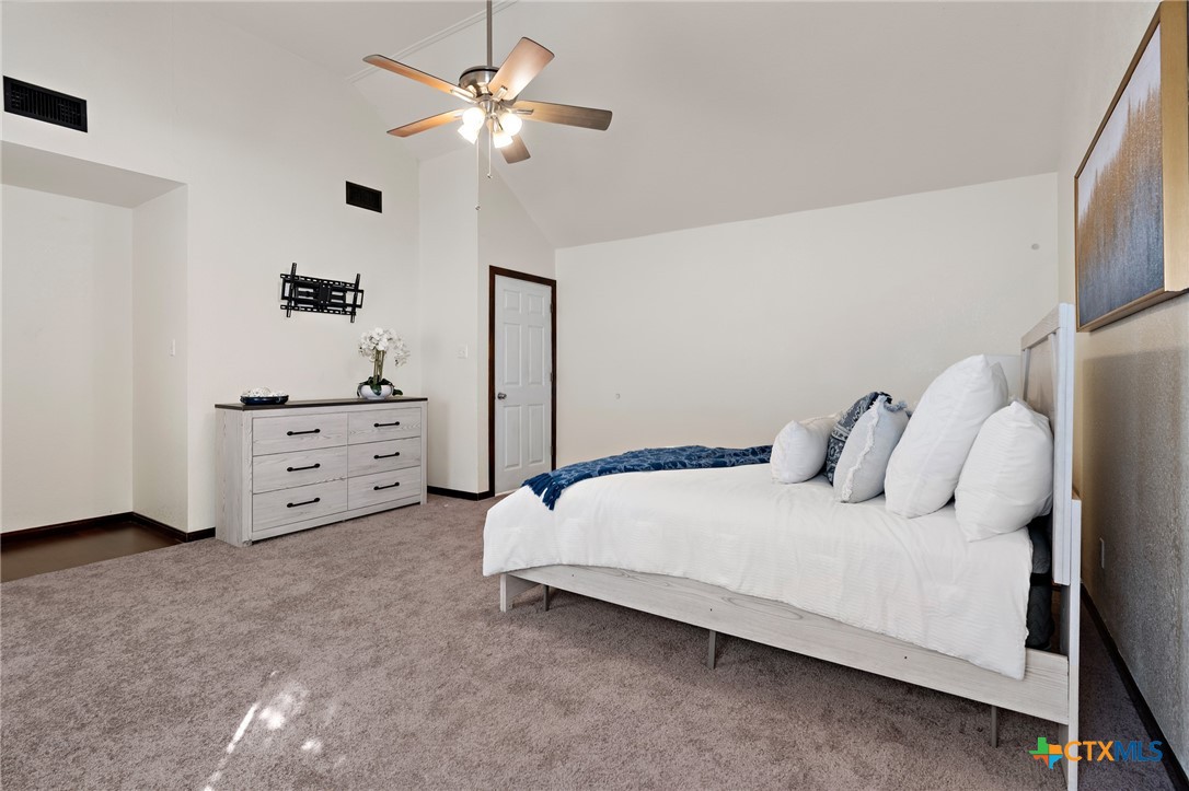 711 Mueller Street Copperas Cove, TX 76522 - Photo 20 of 48 a bedroom with a bed and a chandelier