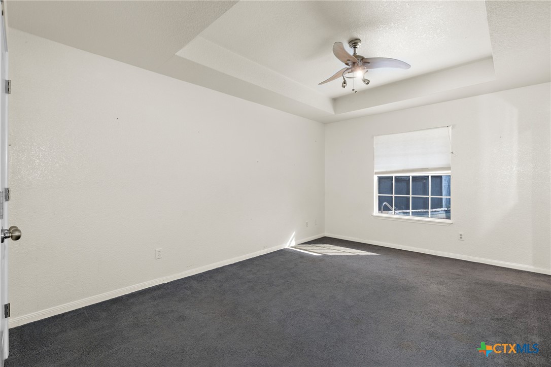 711 Mueller Street Copperas Cove, TX 76522 - Photo 27 of 48 an empty room with ceiling fan and window