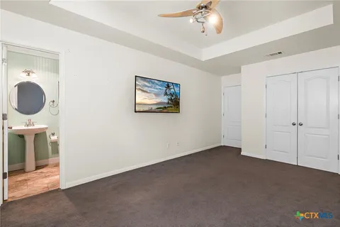 a view of a livingroom with a chandelier fan