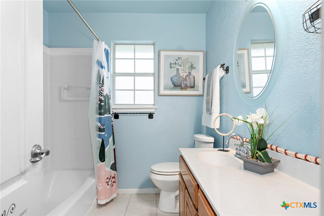 711 Mueller Street Copperas Cove, TX 76522 - Photo 31 of 48 a bathroom with a sink a toilet and tub