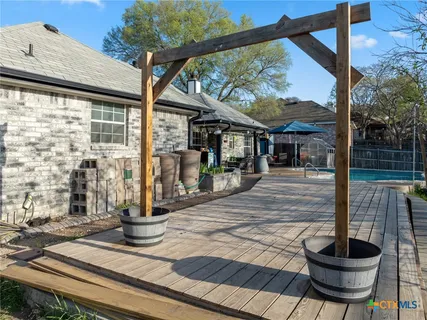 a view of a house with backyard and sitting area