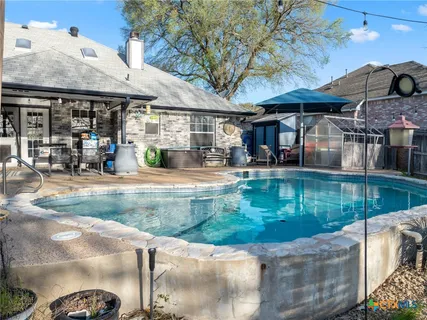 a view of a swimming pool with a patio