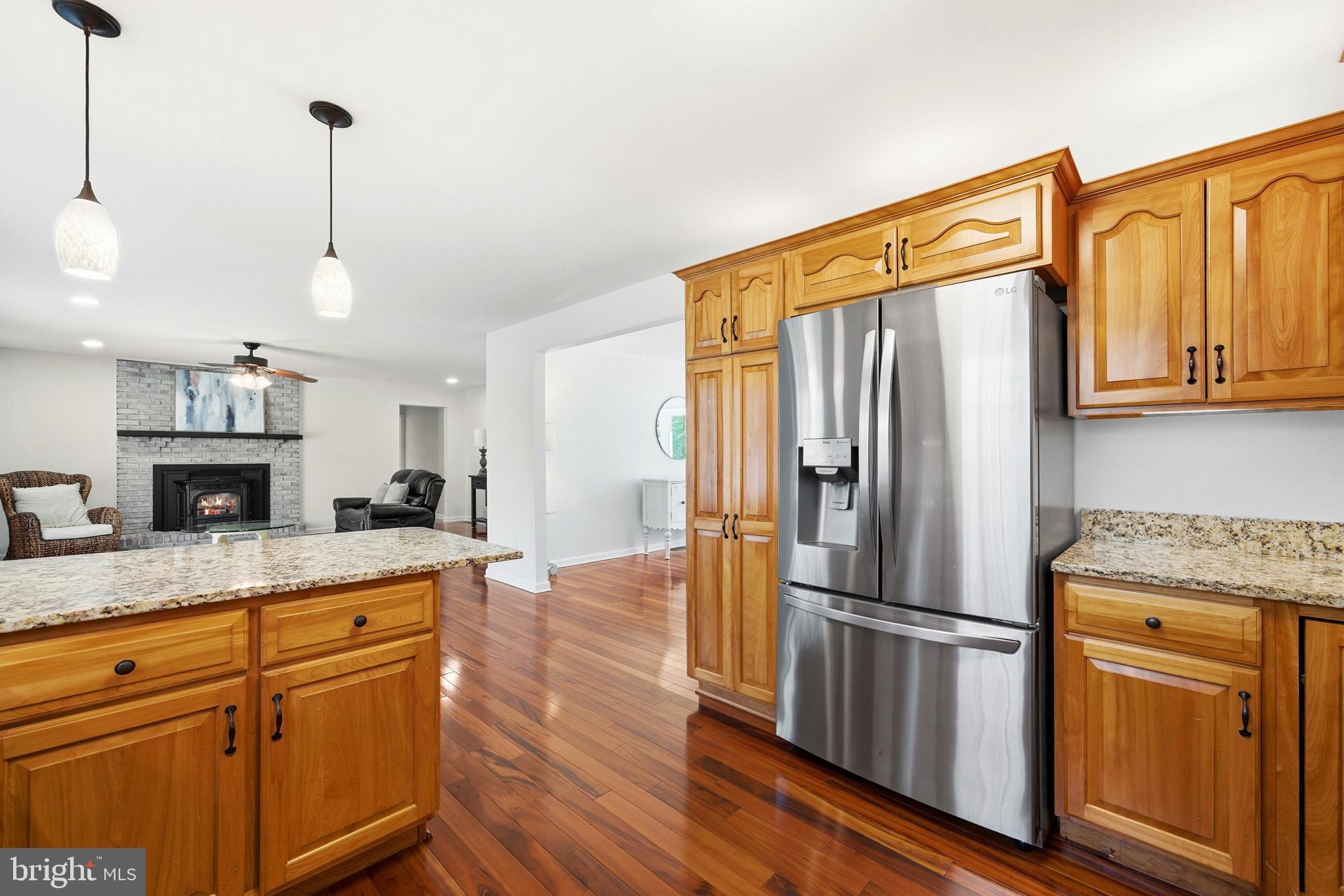 7219 Carrico Mill Road Hughesville, MD 20637 - Photo 13 of 41 a kitchen with stainless steel appliances granite countertop a refrigerator a stove and a wooden floors