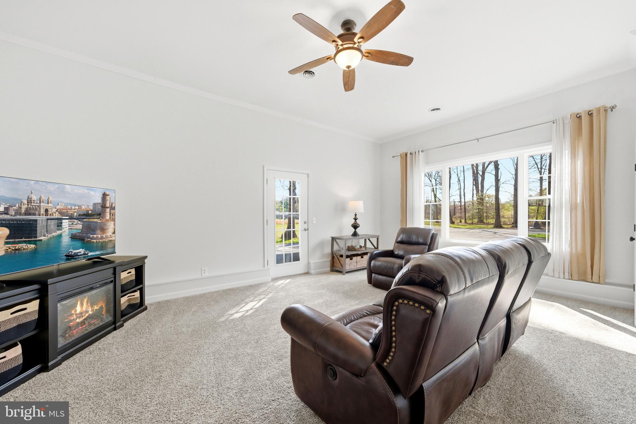 7219 Carrico Mill Road Hughesville, MD 20637 - Photo 17 of 41 a living room with furniture a ceiling fan and a window
