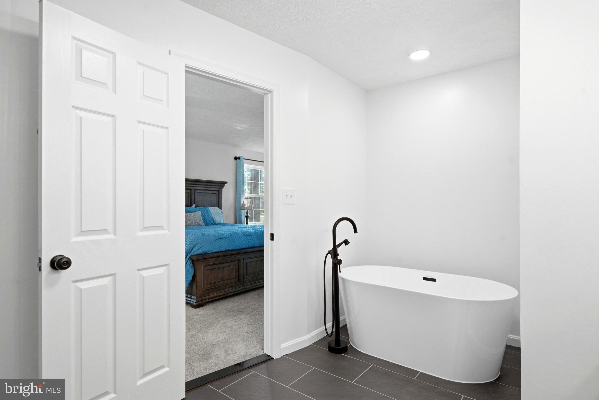 7219 Carrico Mill Road Hughesville, MD 20637 - Photo 21 of 41 a bathroom with a tub and a shower