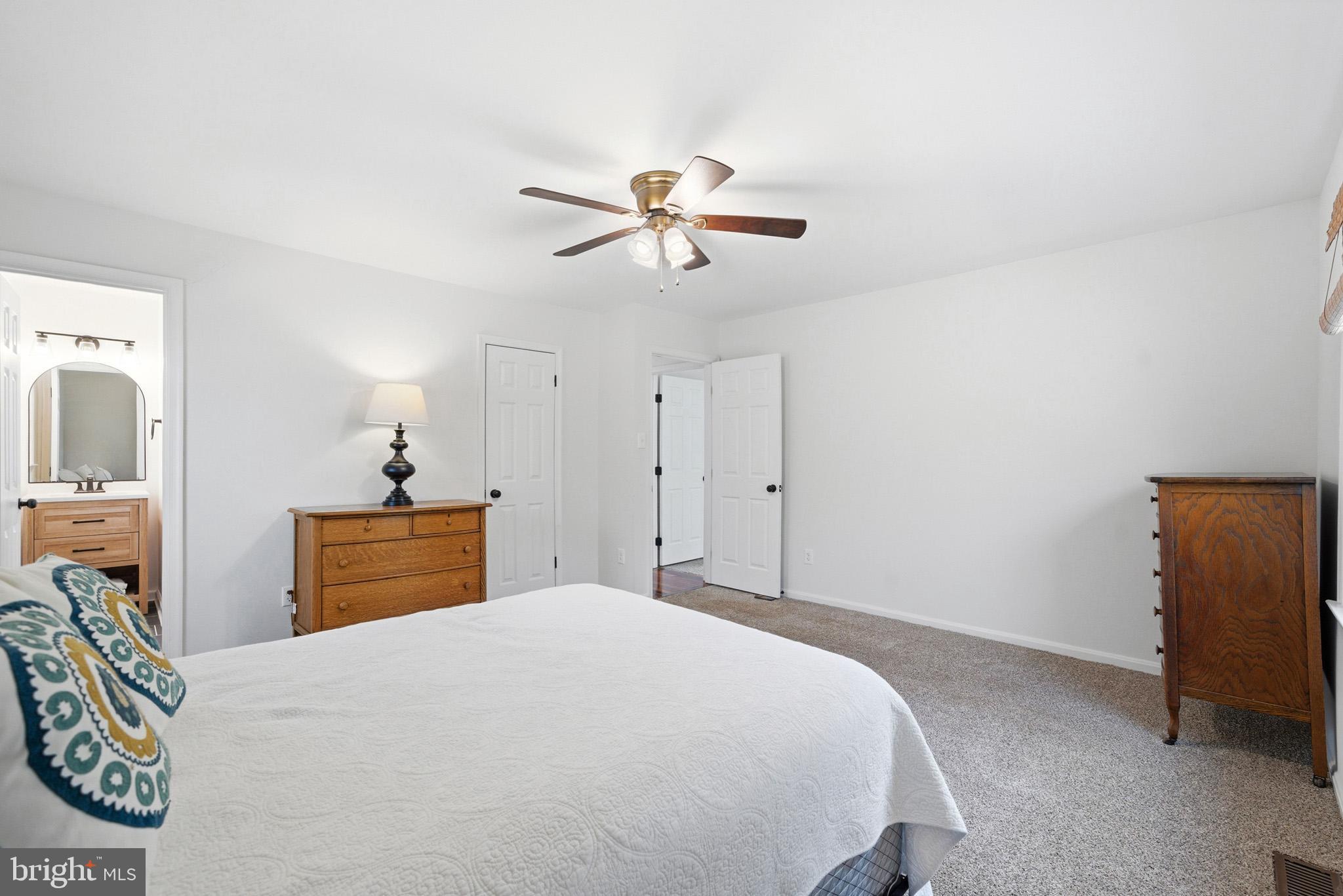 7219 Carrico Mill Road Hughesville, MD 20637 - Photo 23 of 41 a bedroom with a bed and a chandelier