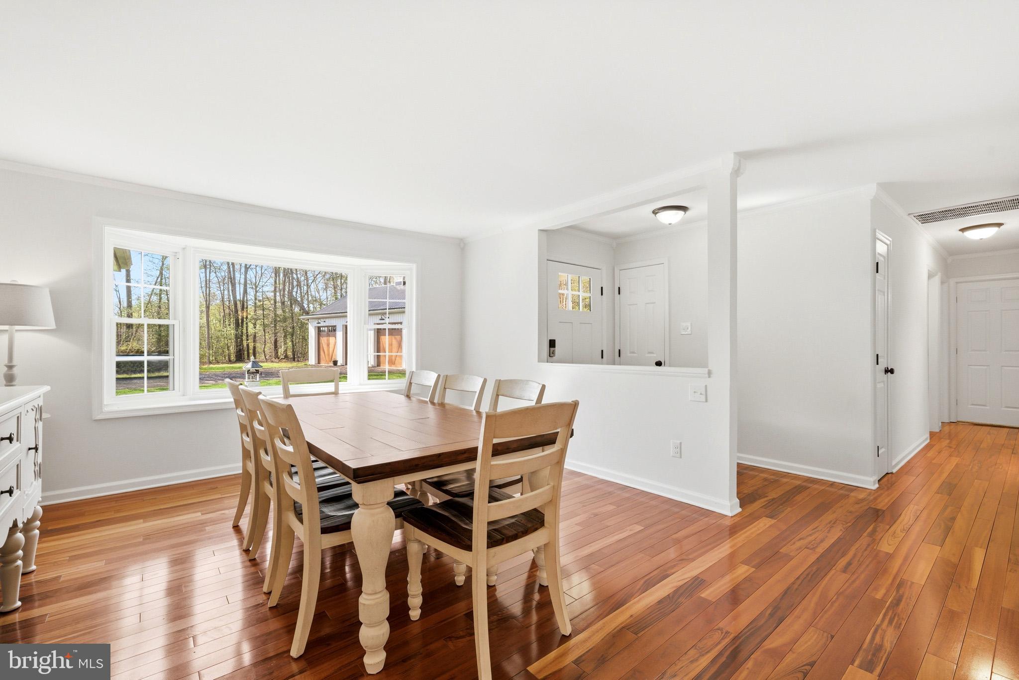 7219 Carrico Mill Road Hughesville, MD 20637 - Photo 6 of 41 a view of a dining room with furniture and wooden floor