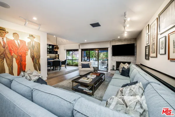 a kitchen with stainless steel appliances granite countertop a table chairs sink refrigerator and microwave