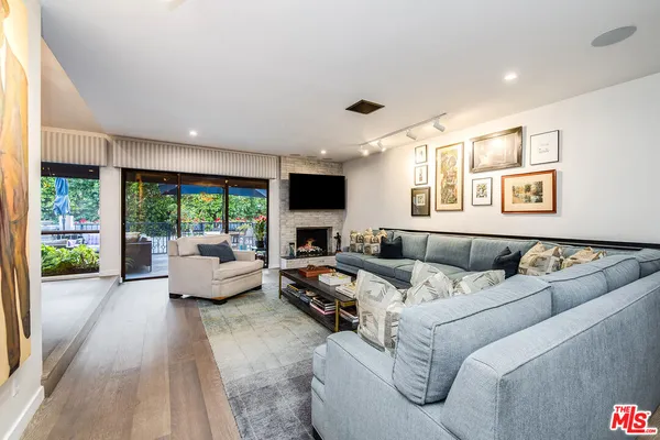 a large kitchen with stainless steel appliances granite countertop a large stove a sink dishwasher and a large countertops with wooden floor