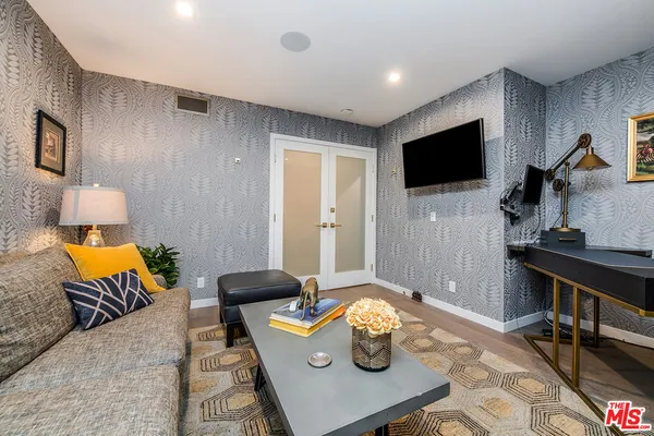 a view of a patio with couches table and chairs and potted plants