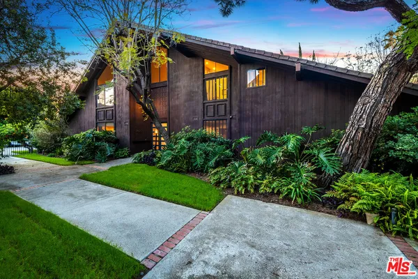 a view of a brick house with a yard