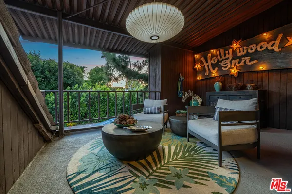 a view of a patio with a dining table and chairs