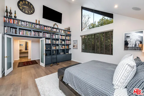 a bedroom with a large bed and a large window