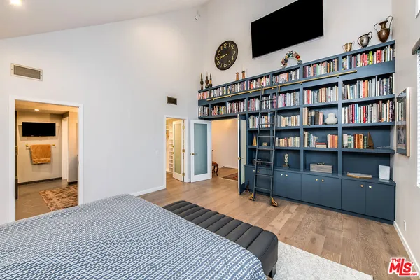 a bedroom with a bed and couch