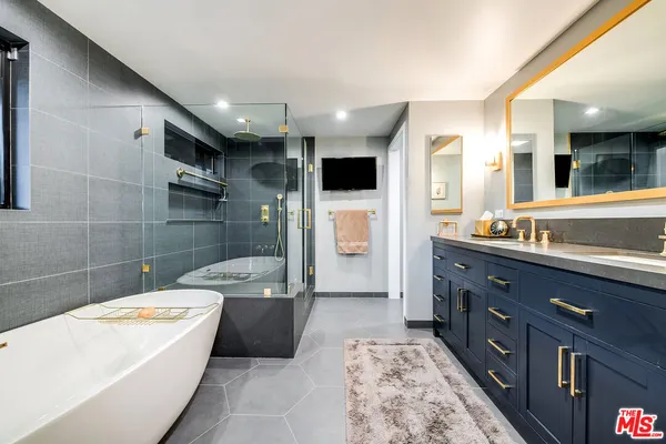 a spacious bathroom with a double vanity sink a toilet and a shower
