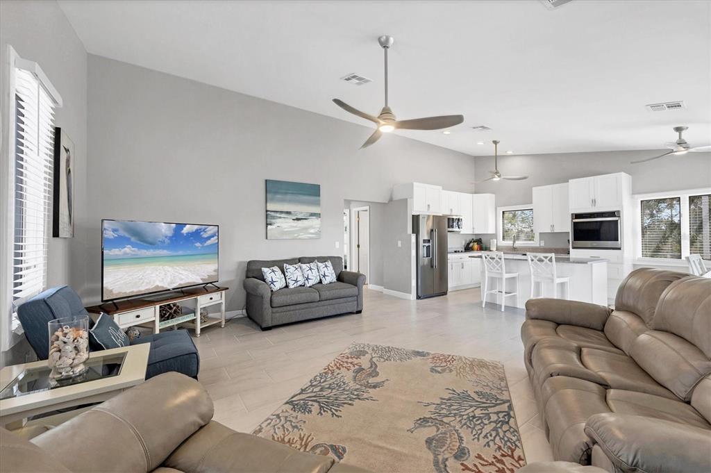 331 Bocilla Drive Boca Grande, FL 33921 - Photo 13 of 34 a living room with furniture kitchen view and a flat screen tv