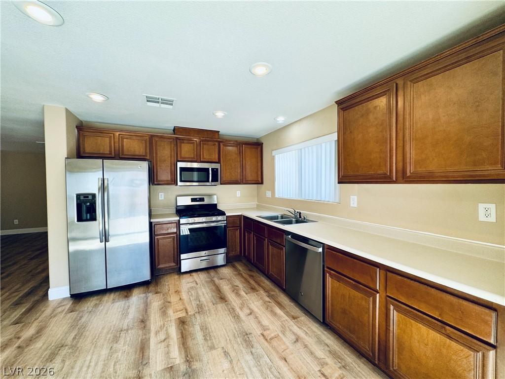 8617 Palomino Ranch Street Las Vegas, NV 89131 - Photo 10 of 27 A contemporary kitchen features sleek stainless steel appliances and abundant cabinetry.