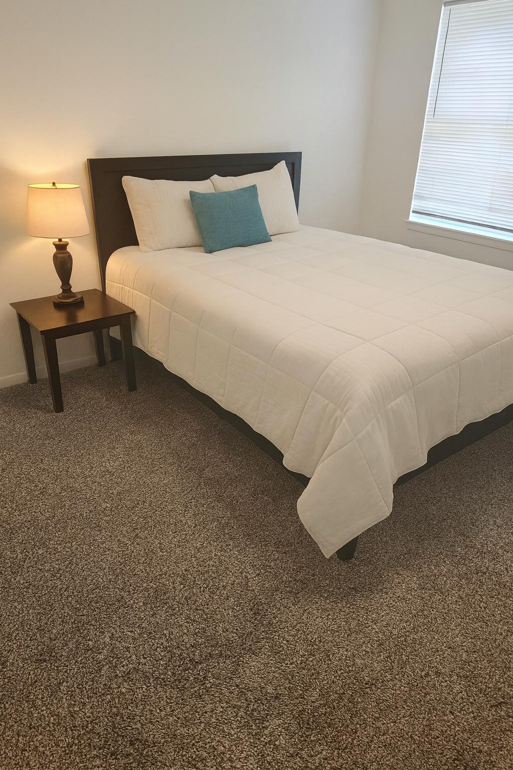 600 Hilliard Street, Unit 2 Conroe, TX 77301 - Photo 12 of 21 a bedroom with a bed and a window