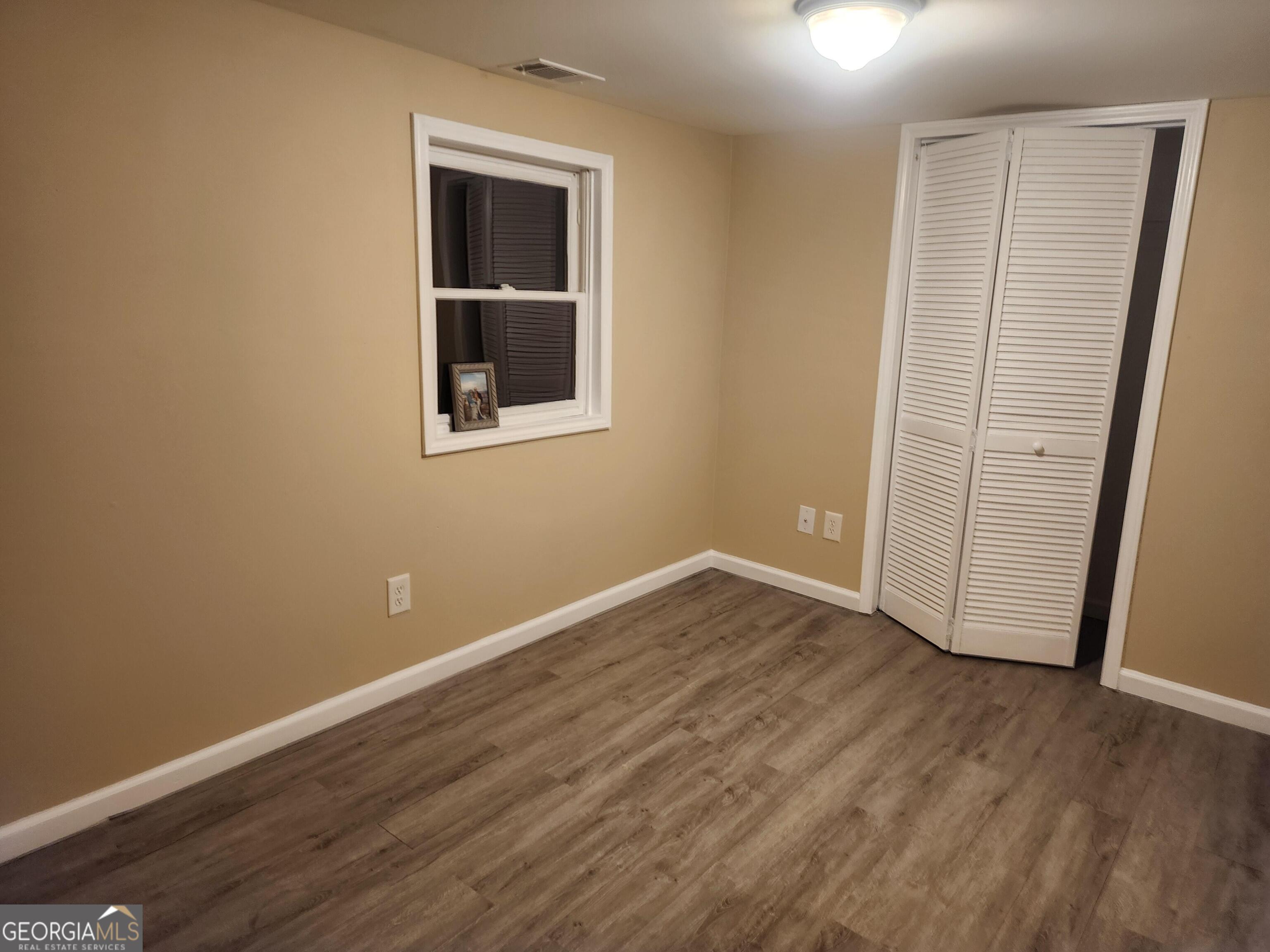 2125 Westbrook Road Commerce, GA 30530 - Photo 14 of 25 an empty room with wooden floor and windows
