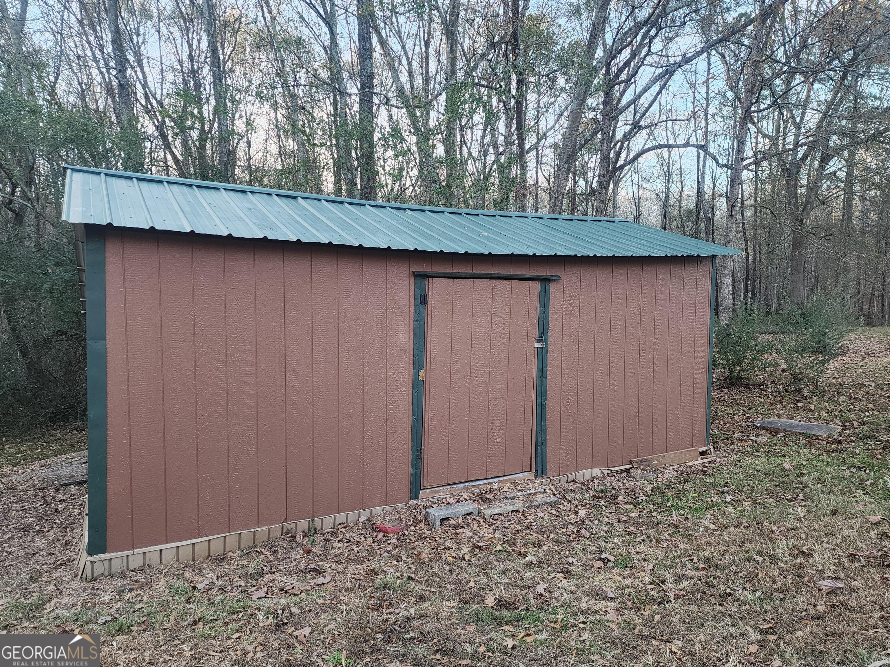 2125 Westbrook Road Commerce, GA 30530 - Photo 24 of 25 a backyard of a house with large trees and wooden fence