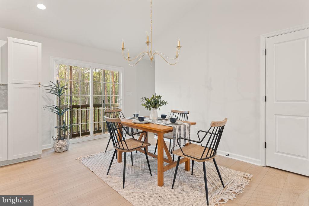 729 Vawter Corner Road Louisa, VA 23093 - Photo 11 of 50 a view of a dining room with furniture and wooden floor