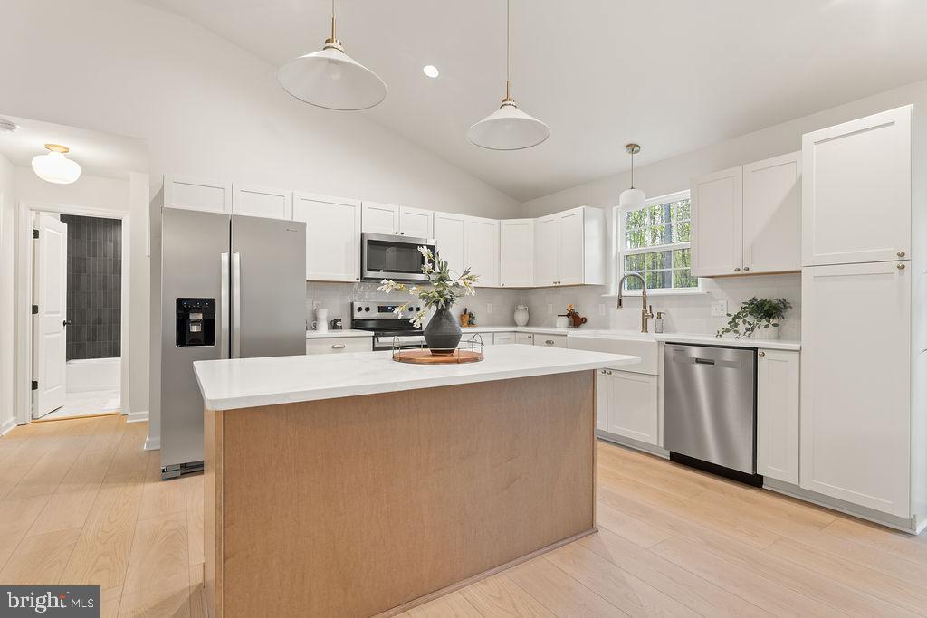 729 Vawter Corner Road Louisa, VA 23093 - Photo 13 of 50 a kitchen with white cabinets and stainless steel appliances