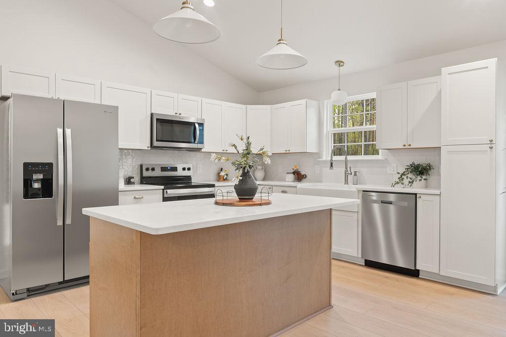 729 Vawter Corner Road Louisa, VA 23093 - Photo 14 of 50 a kitchen with stainless steel appliances a refrigerator sink and microwave