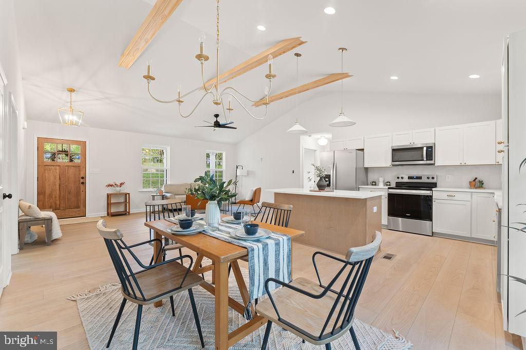 729 Vawter Corner Road Louisa, VA 23093 - Photo 16 of 50 a view of a dining room and kitchen with furniture a chandelier and wooden floor