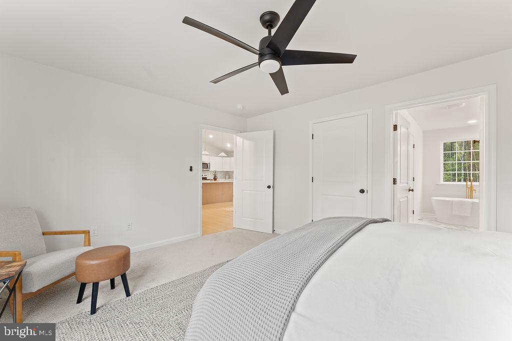 729 Vawter Corner Road Louisa, VA 23093 - Photo 18 of 50 a bedroom with a bed a desk and chair