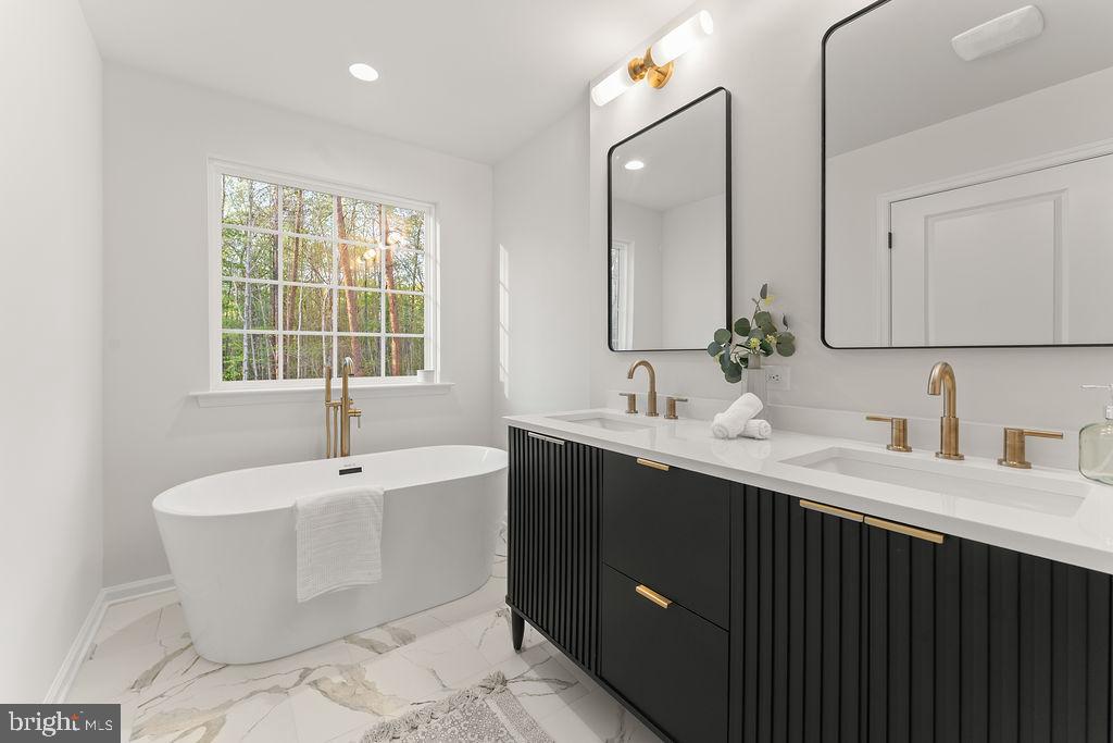 729 Vawter Corner Road Louisa, VA 23093 - Photo 21 of 50 a bathroom with a tub sink and mirror